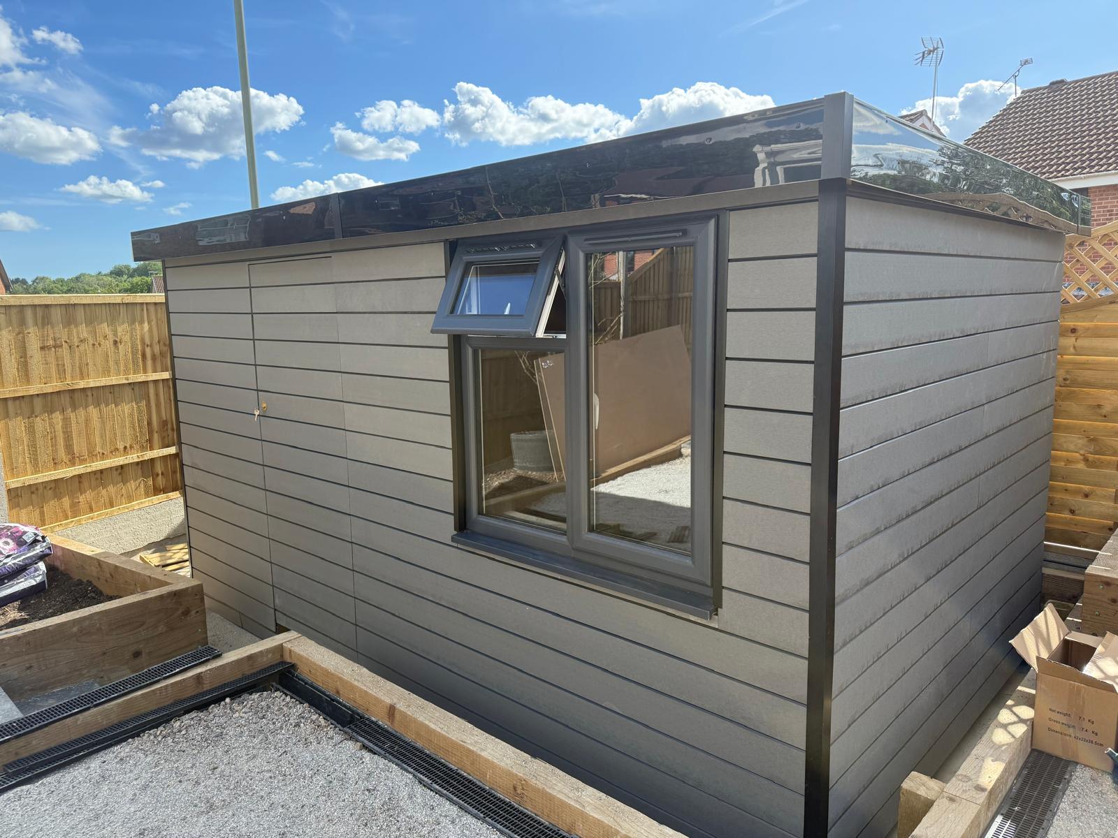  Grey upvc cladd garden office in a landscaped garden 