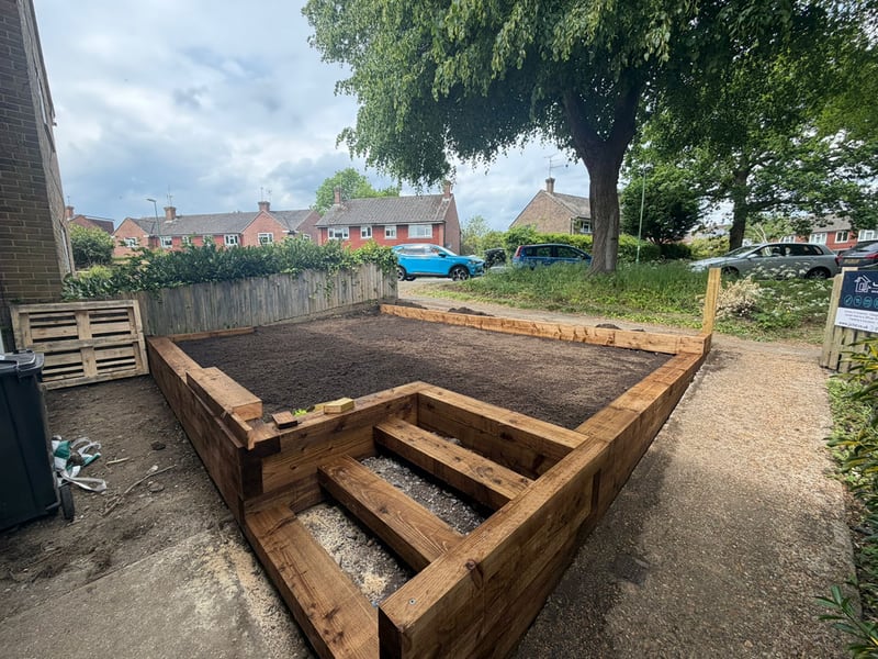 Ongoing construction of a front garden area on 2 levels and contained in railway sleeper type wooden construcion