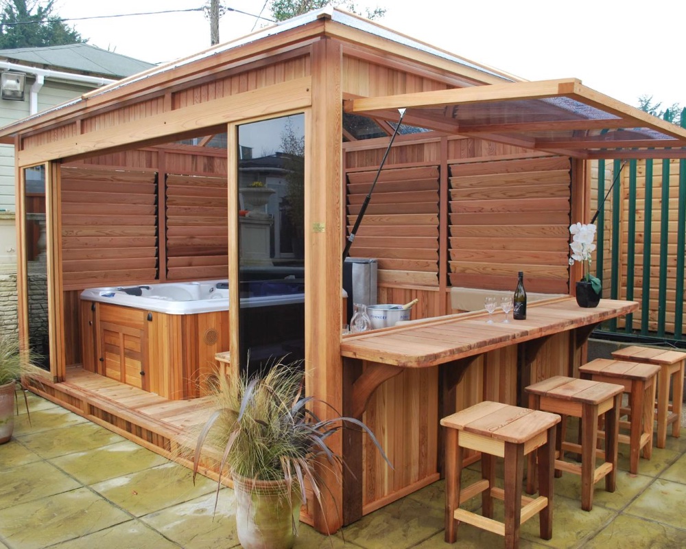 Custom wooden hot tub shelter with integrated bar area and seating