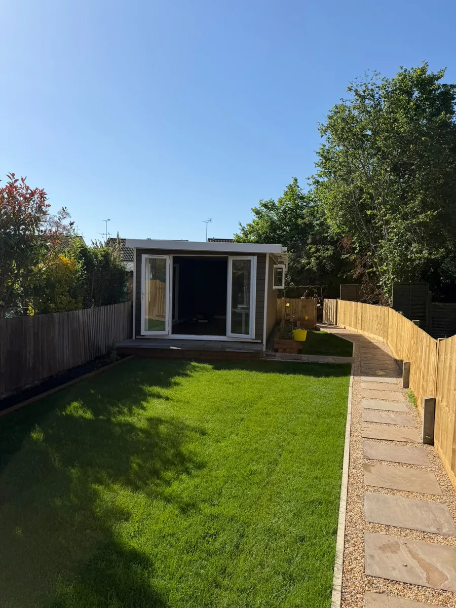 Finished garden room at the end of a new lawn with a stepping-stone path