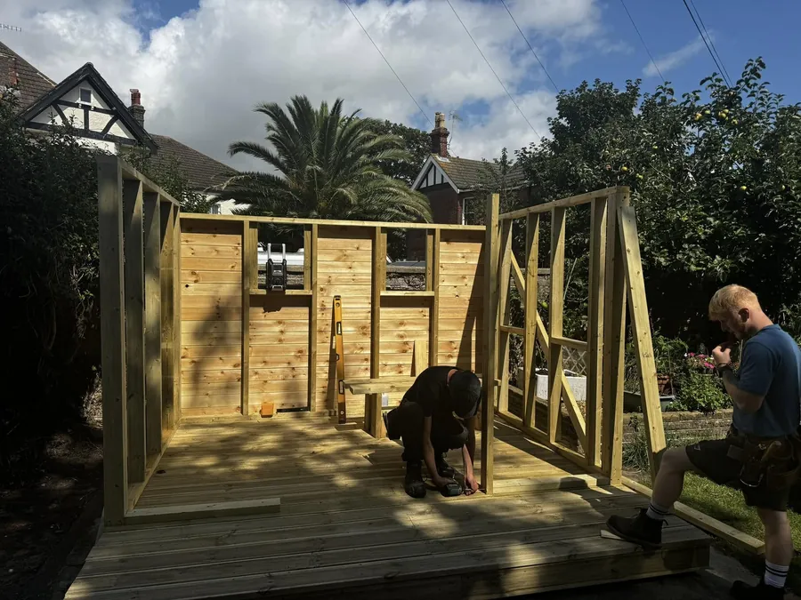 Two of the JJC team building a timber frame on site